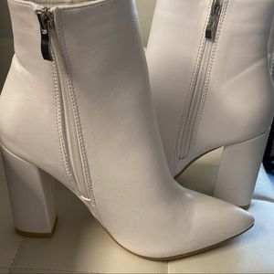White bootie heels. Never worn. Size 6. Zip up on insides. 3.5 inch heel